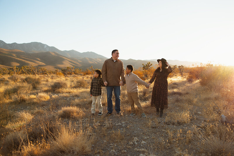 mom and dad snuggling on the couch with their new baby girl