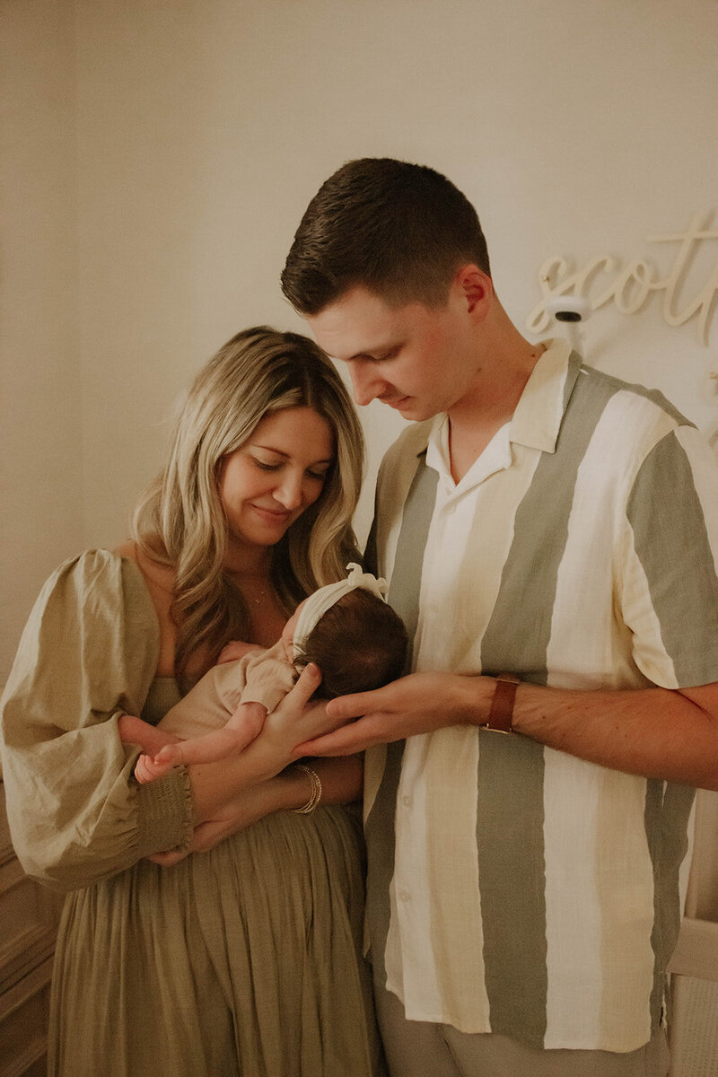 mom and dad holding newborn