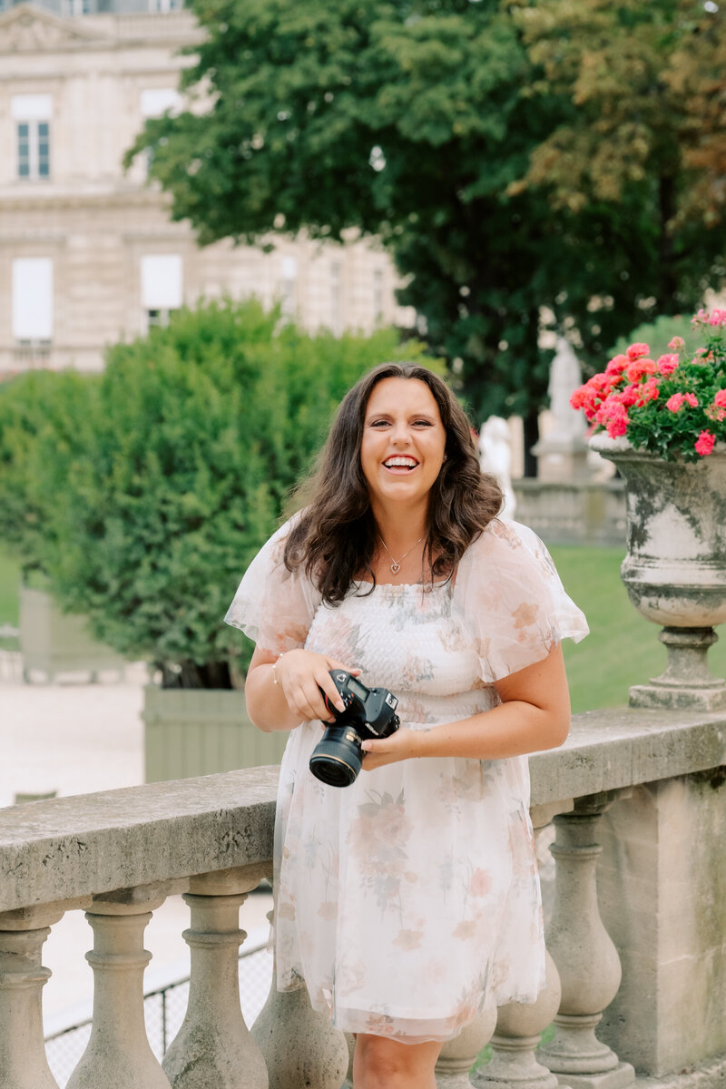 dana, a monterey wedding photographer, in a white dress with camera. 