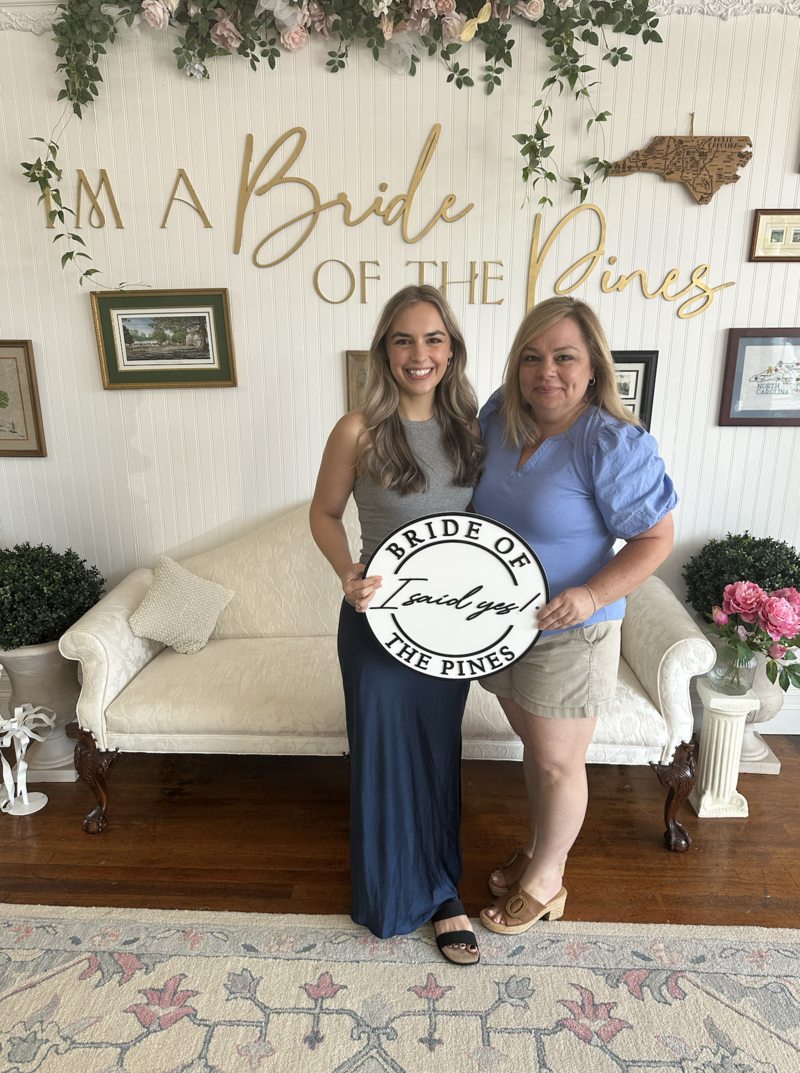 Bride with mom celebrating saying yes to her dress
