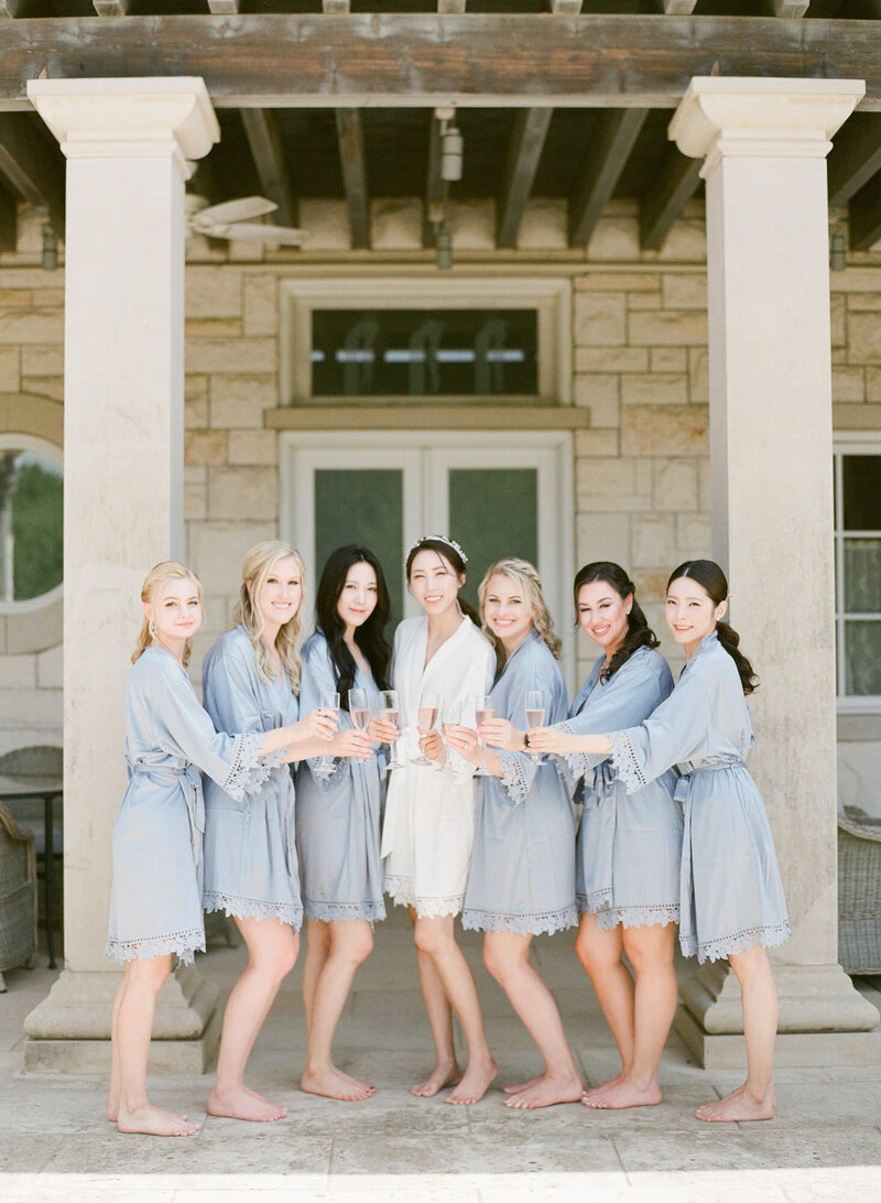 Bride celebrates with her bridesmaids while getting ready for the olana wedding