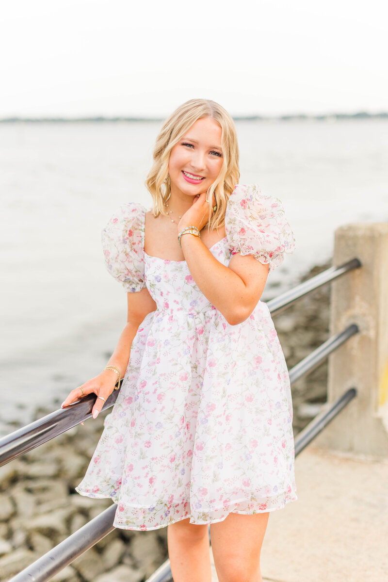 groom dipping bride back and kissing her with water and palm trees in the background