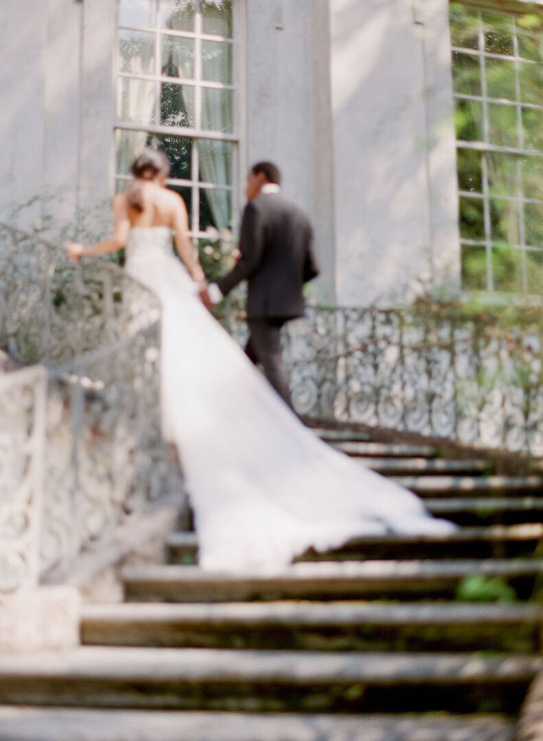 Bride and Groom Walking Up Stairs at The Swan House Photo
