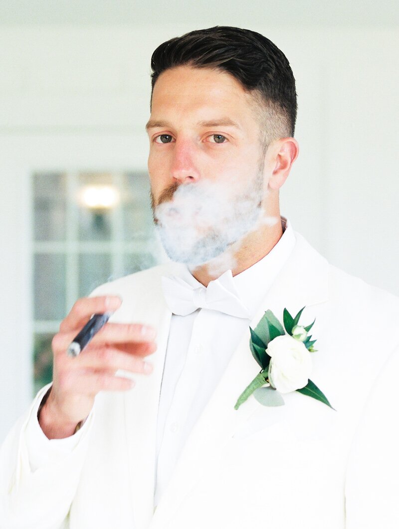 bride and groom touching each others faces while closing their eyes