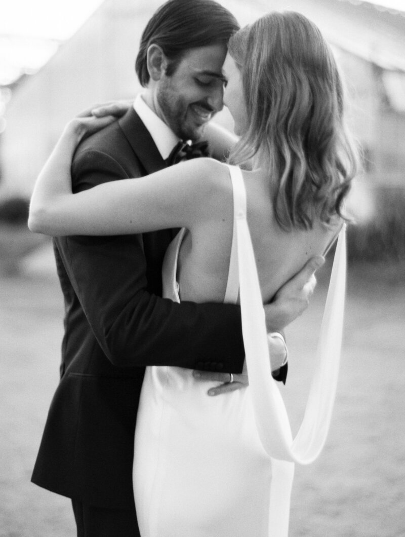 black and white wedding image of couple embracing