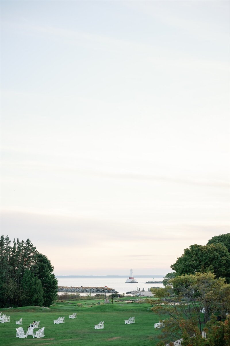 The view of a lighthouse from a balcony at Mission Point Resort on Mackinac Island
