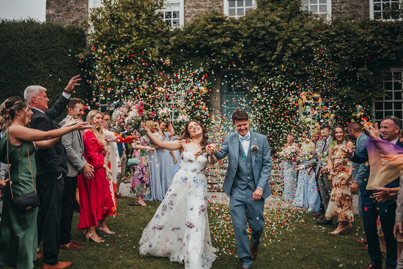 bride and groom in a shower of confetti
