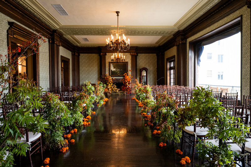 University Club ceremony with seasonal autumn decor and crystal chandeliers - San Francisco wedding photographer