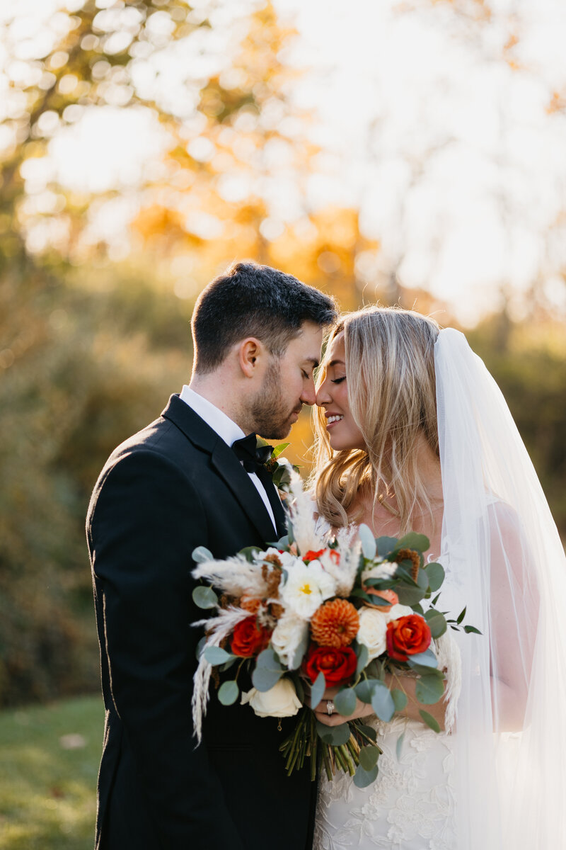 bride and groom smiling at eachother