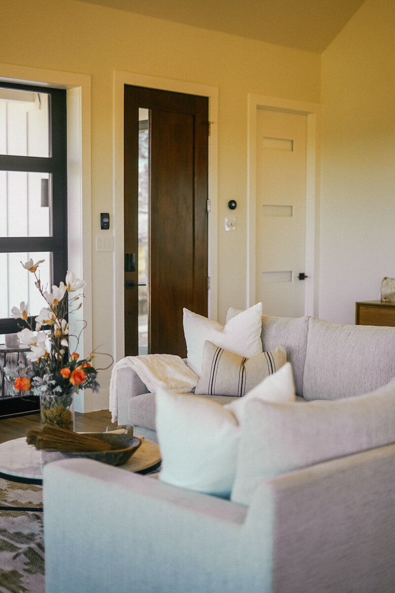 Living room with light grey couch and round coffee table