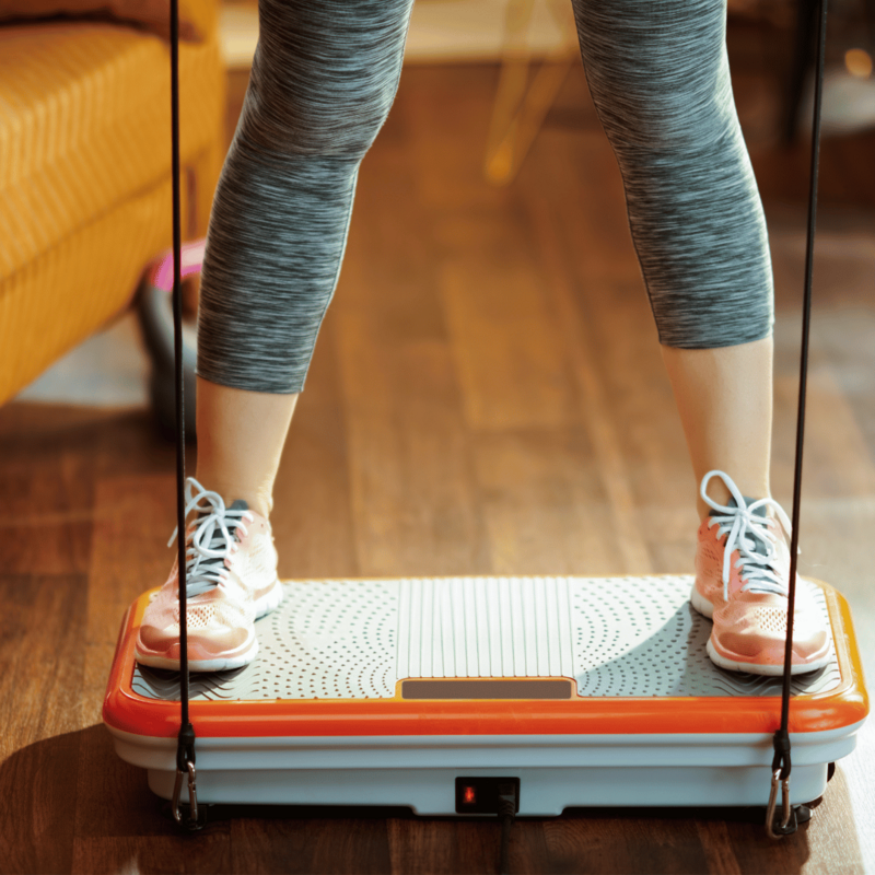 Woman standing on the vibration plate
