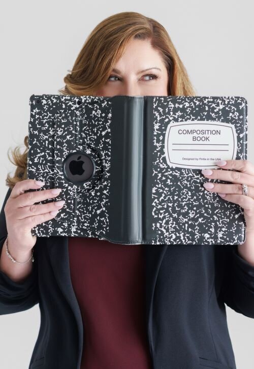 woman holding an ipad up to her face with eyes showing and  looking to the left side
