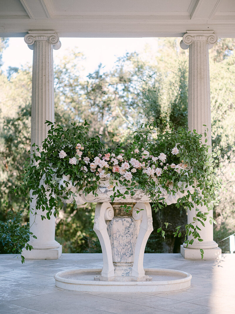 Wedding altar decorated with greenery and blush flowers