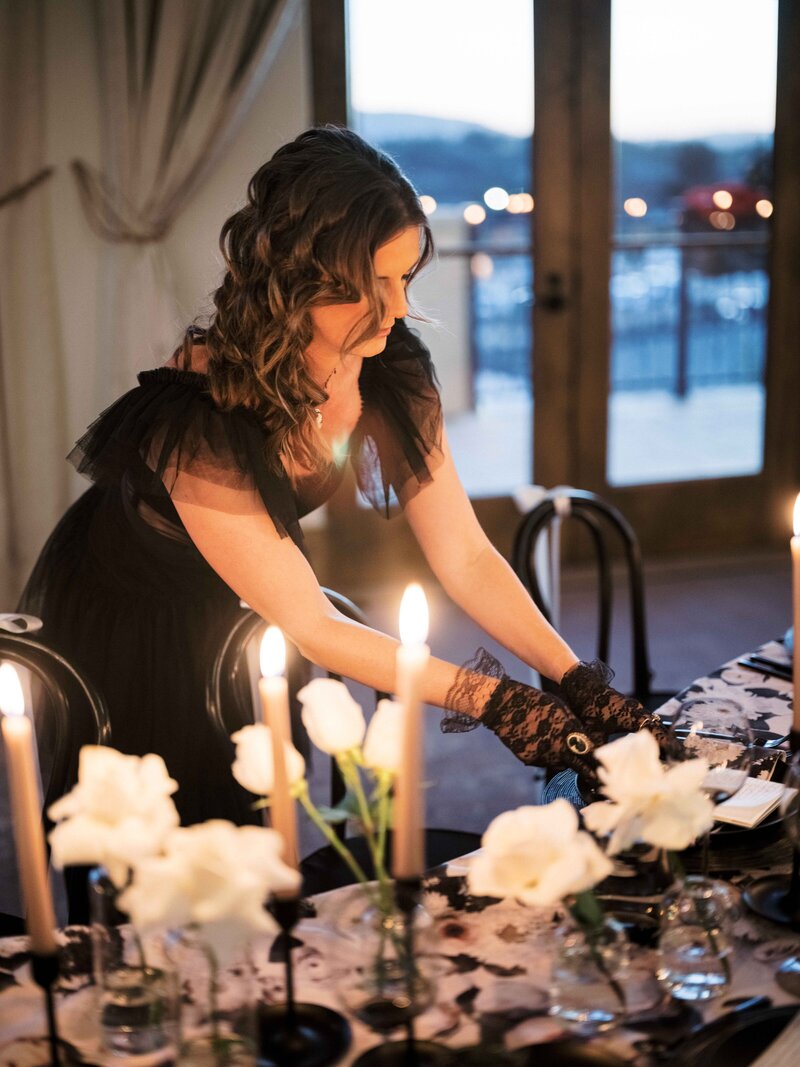 California Wedding Planner adjusting the place setting on a tablescape.