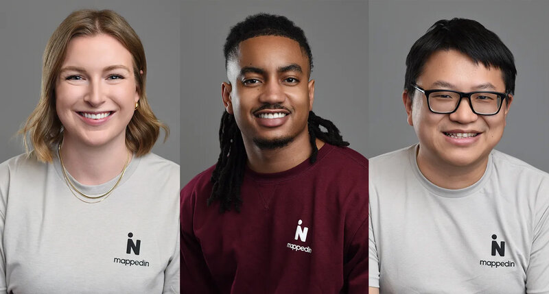 Grid of diverse team headshots wearing branded attire, set against a uniform gray background, reflecting company culture and inclusivity.