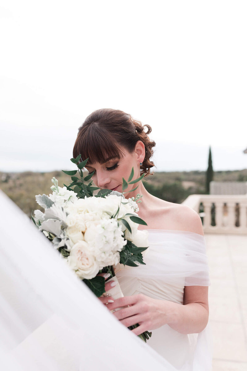 bride smells her bridal bouquet during her bridal session in Houston by Swish and Click Photography