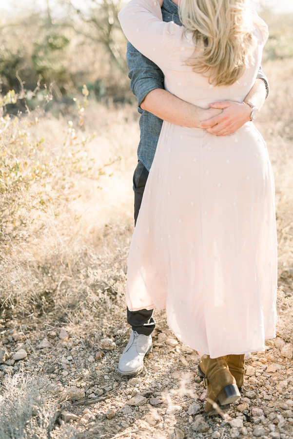 Tucson Desert Engagement Session Photo of Couple Hugging at Gates Pass During Golden Hour | Tucson Wedding Photographer