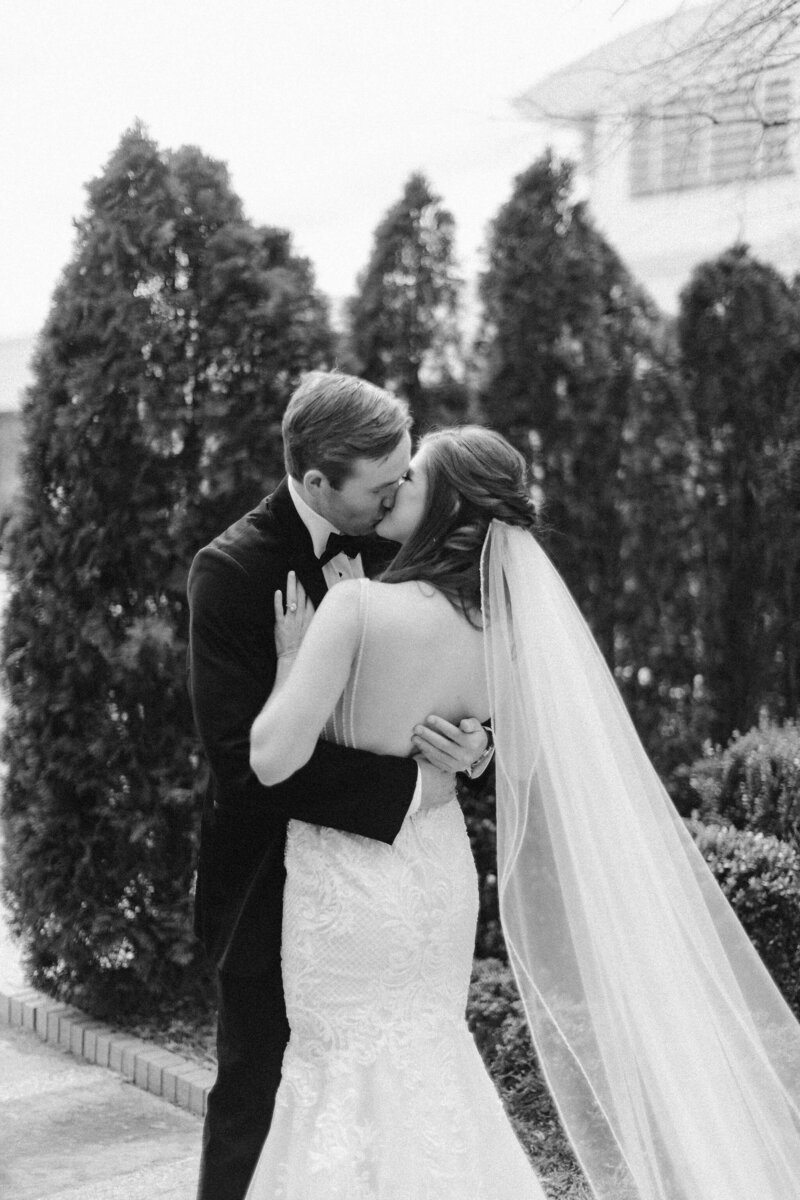 bride and groom kissing in warm embrace