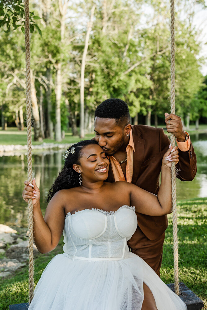 Groom lifting and twirling his bride with glee just minutes after their wedding ceremony