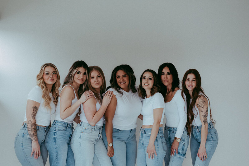 Group of makeup artists posing in black