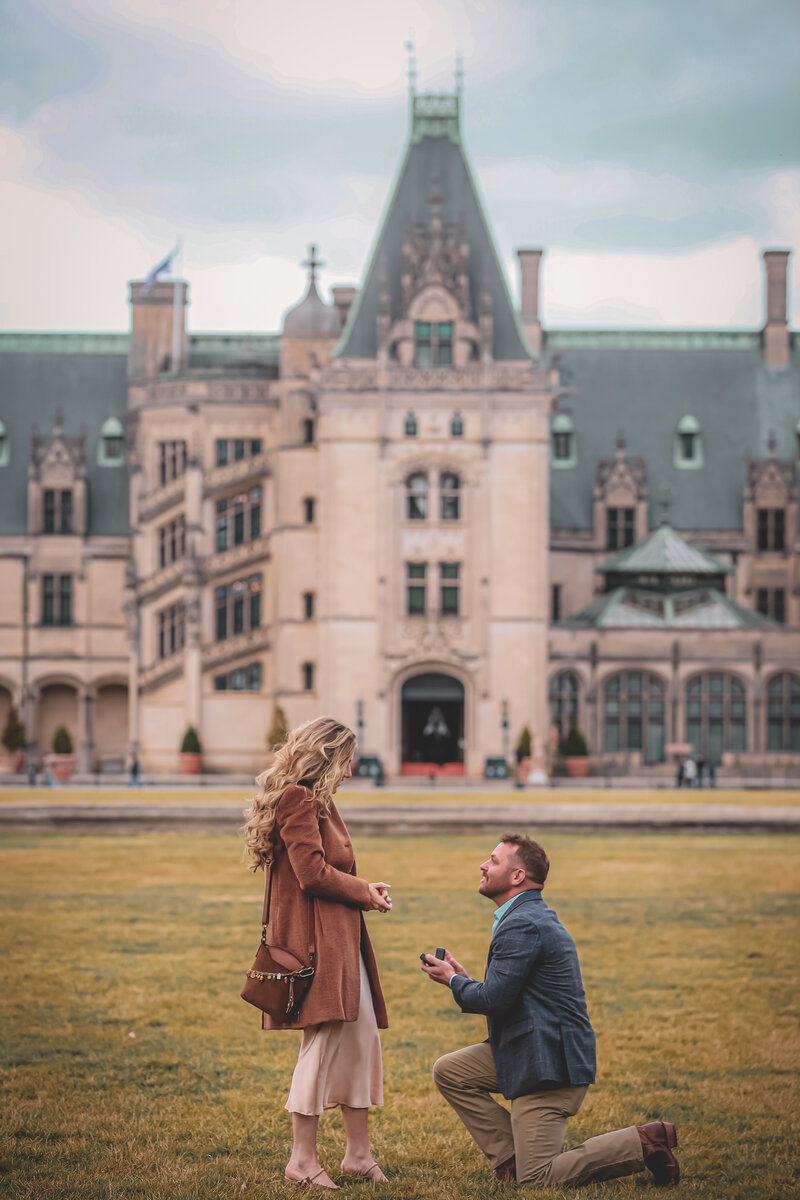 Asheville Photographer Light Shifter Studios captures a man proposing to a women in front of the Biltmore in Asheville, NC. 