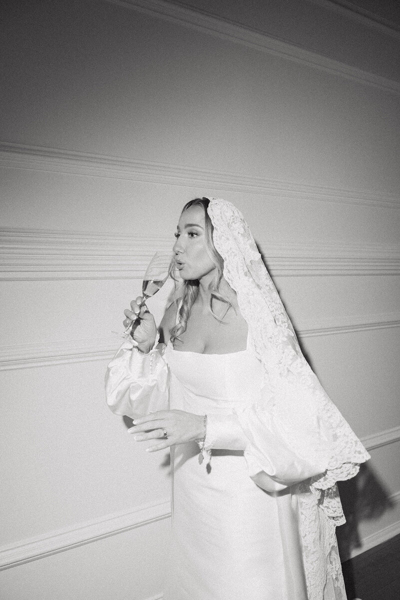 bride drinks champagne during wedding at cescaphe wedding venue in philly pa