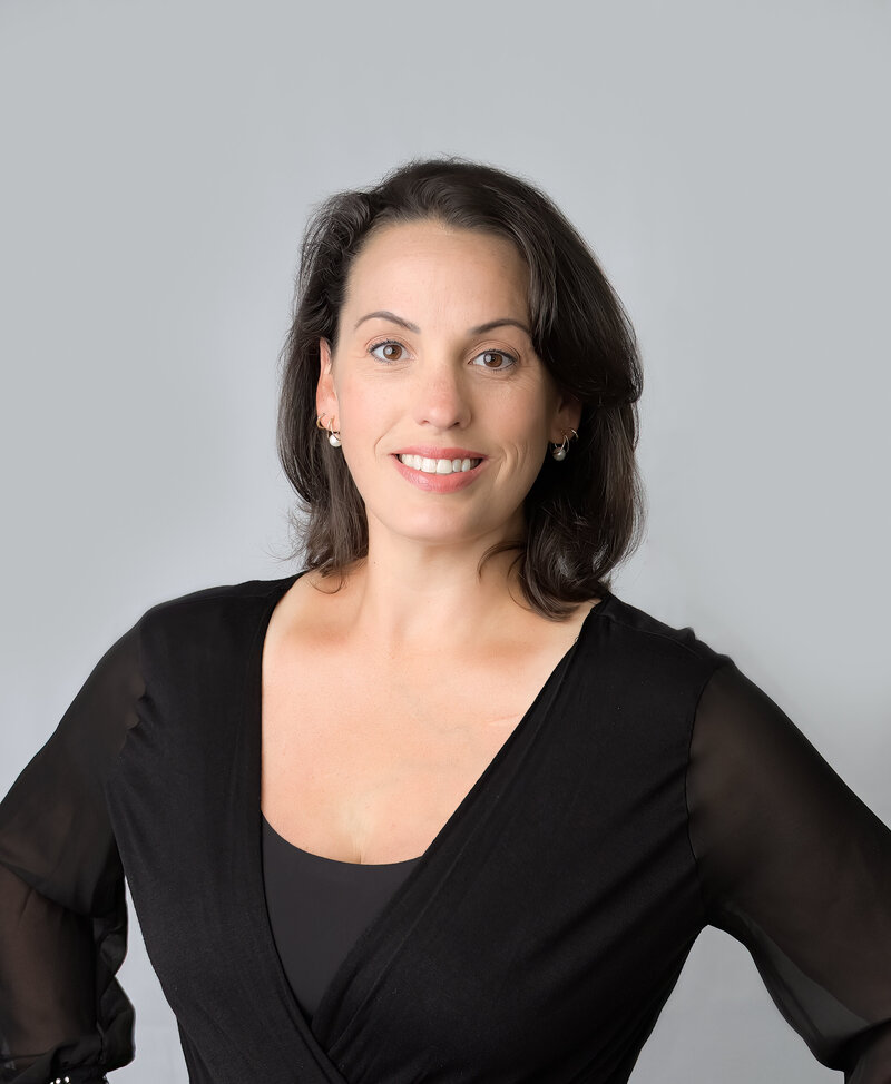 E. Benecki Photography headshot of photographer Beth Benecki on a light gray background.