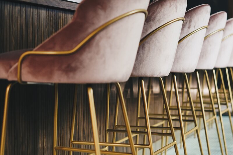 a row of light purple chairs in a row at a bar  socialfizz