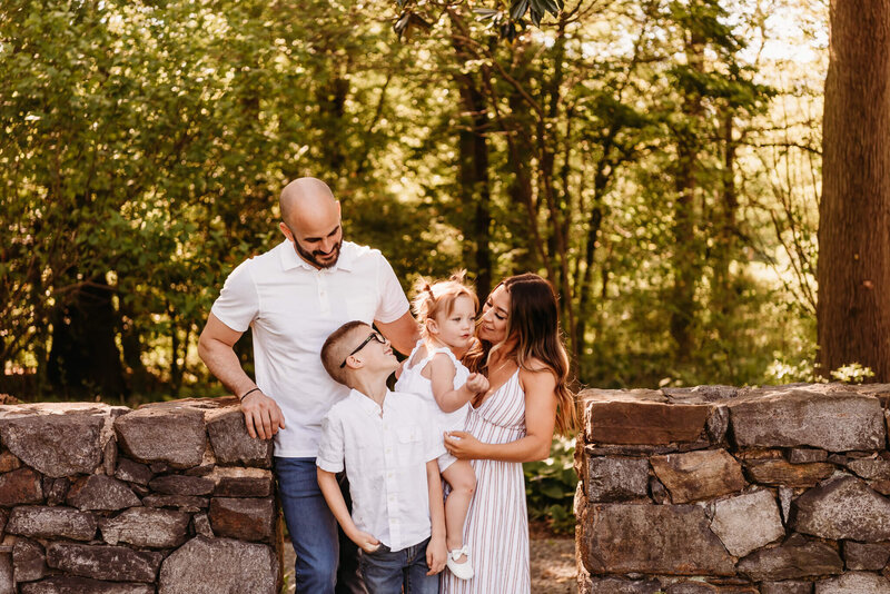 Family of four standing together at Goodstay Gardens during their South Jersey family photography session