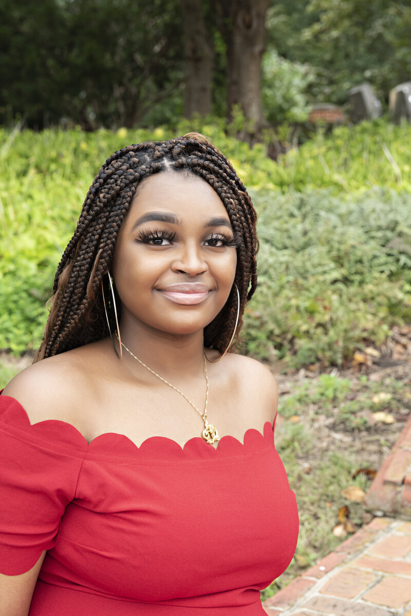 High School Graduate in red dress on University of Maryland Campus