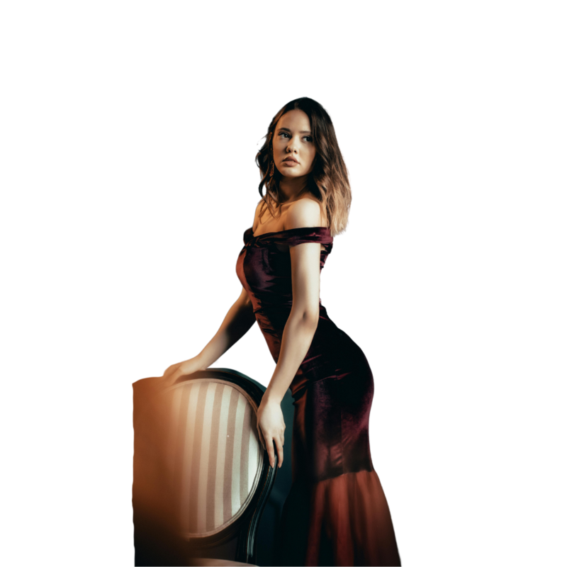 Model standing in a red dress next to a chair for  Elyana Studio Showit Website branding