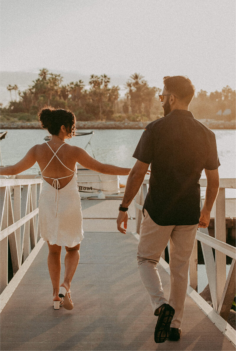 couple walking towards lake