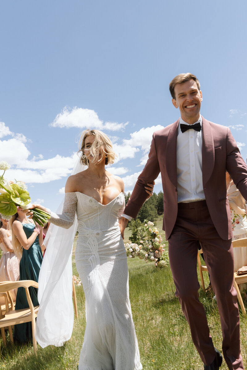 bride and groom walk back down aisle of their luxury wedding ceremony