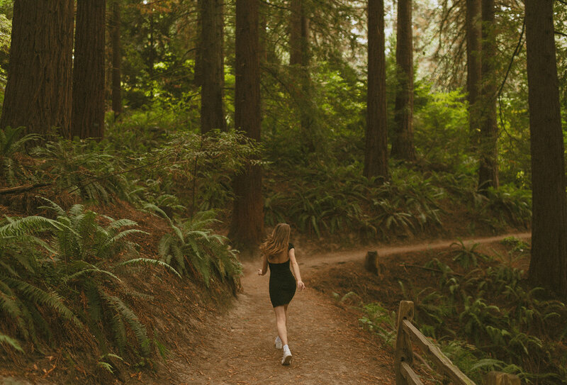 girl standing in forest in portland nature park