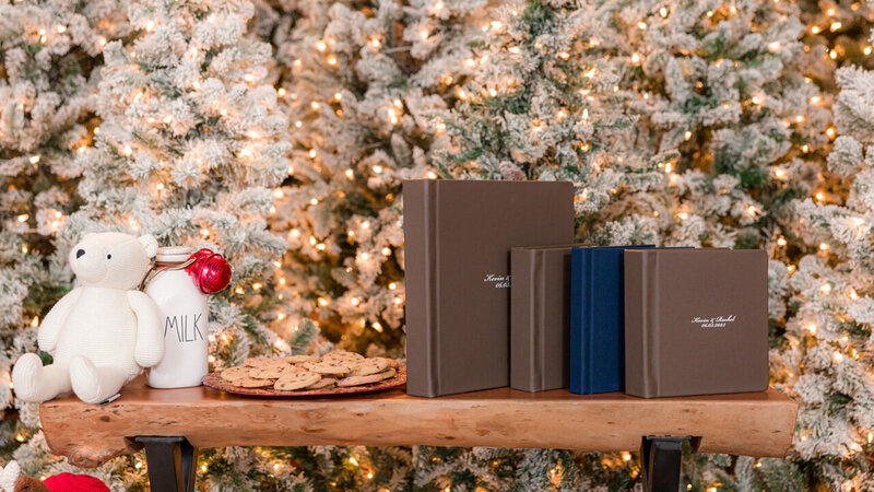A large wedding album displayed alongside three smaller parent albums, showcasing a cohesive and elegant collection.