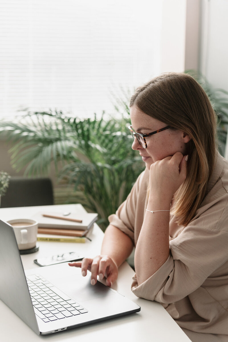 brand and website designer working in her aesthetic office