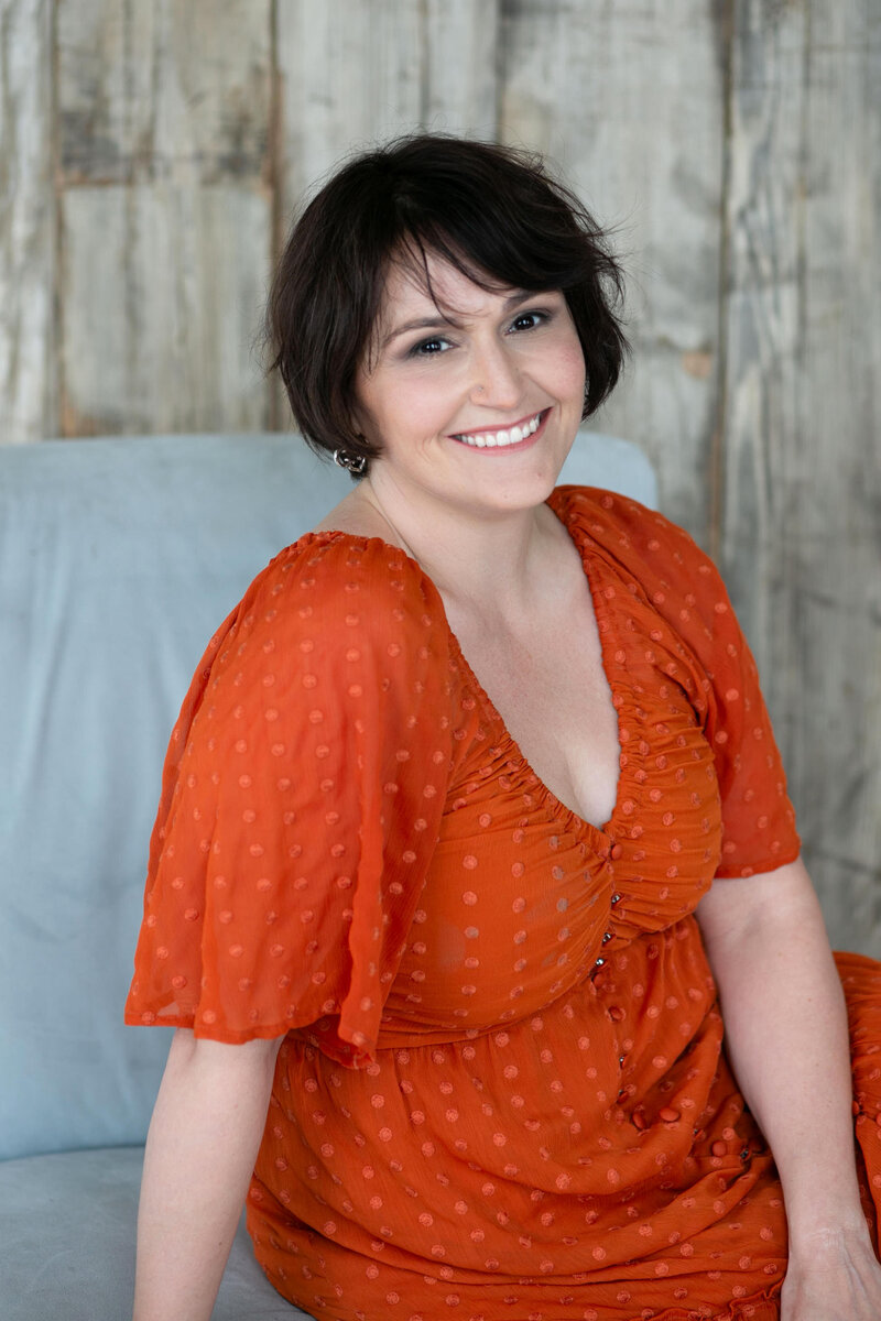 A woman sitting on a chair smiling