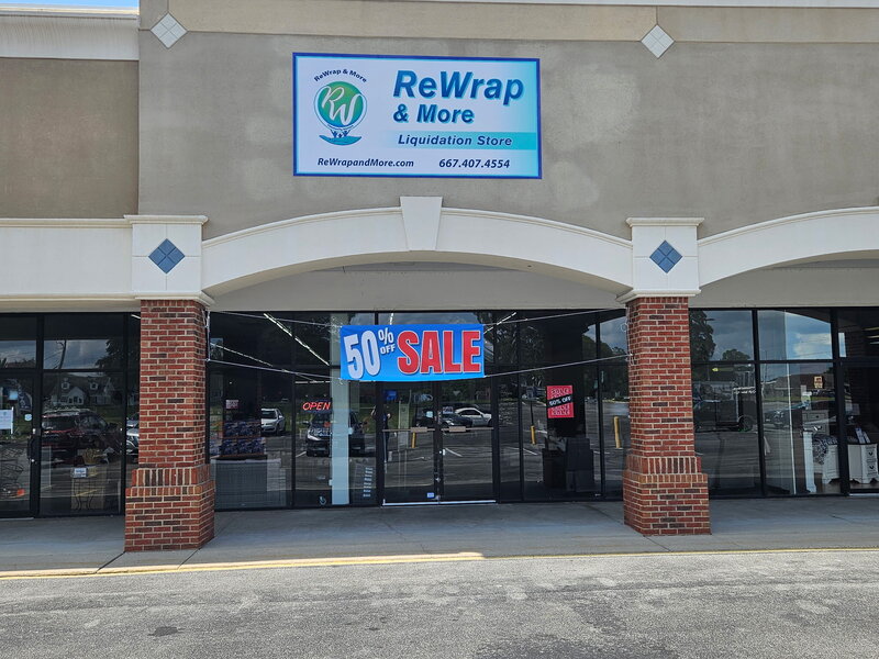 3 women standing in front of coming soon banner at a new liquidation store