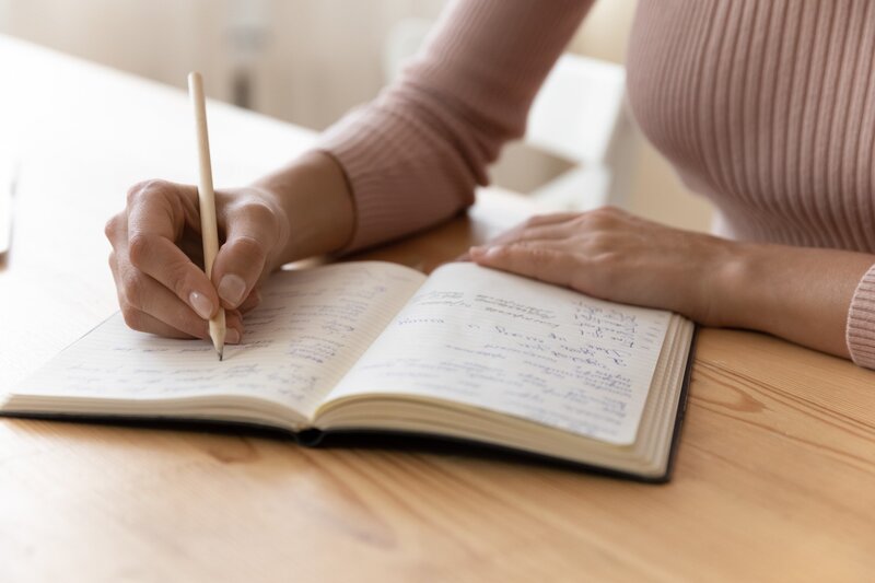 Person writing in journal