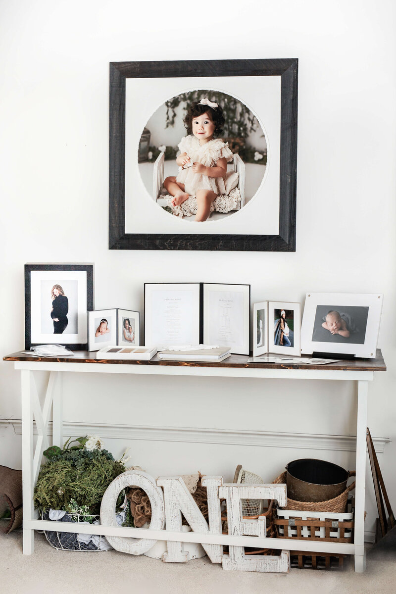 photography studio  photo with framed wall art above a table with products