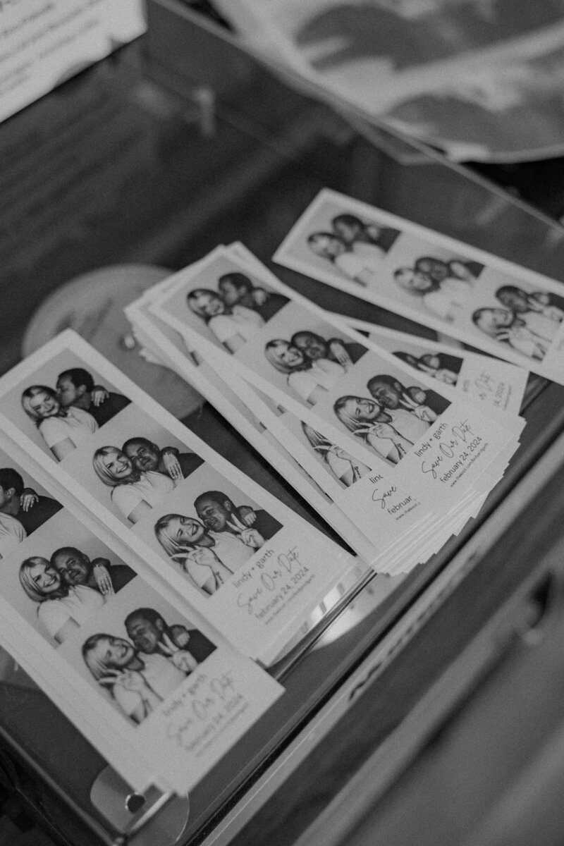 Black and white wedding photo booth strips displayed as a personalized reception detail, styled by Beyond the Event.