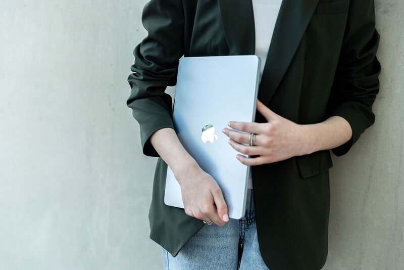 Close-up of a person holding a laptop