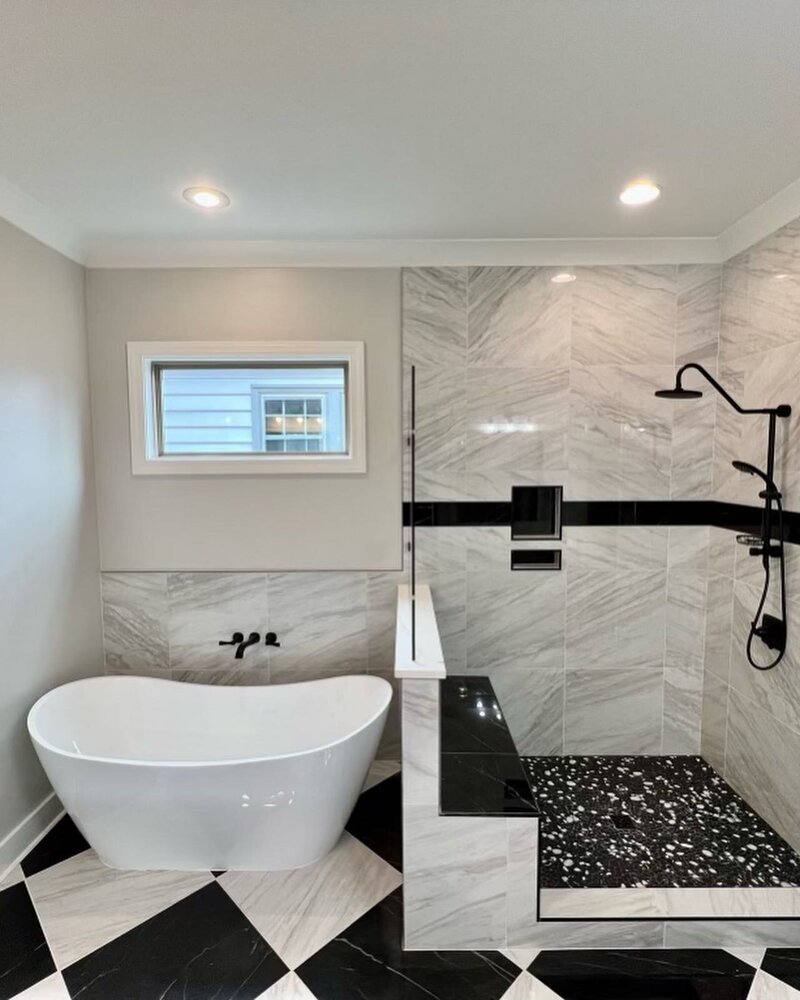 Custom shower with black and white tile.
