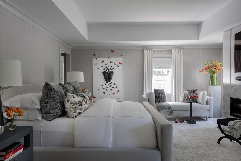 Modern primary bedroom retreat designed by Boston interior designer, featuring soft neutrals and custom furnishings