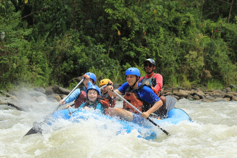 family navigates white water rapids in costa rica