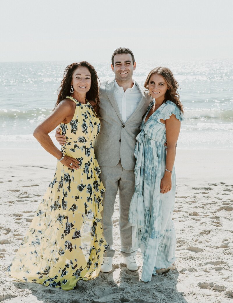 Groom with mom and sister on beach at San Diego micro wedding