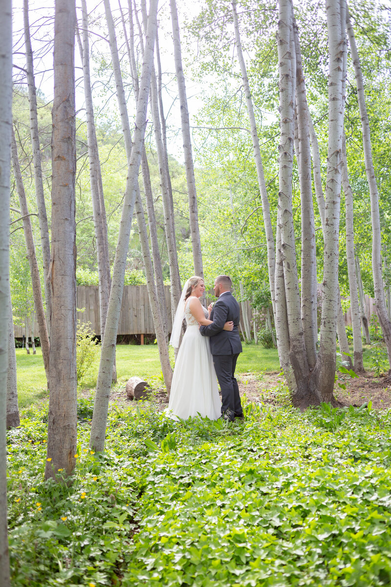 Affordable Washington elopement photographer captures bride wearing wedding ring and veil during forest wedding