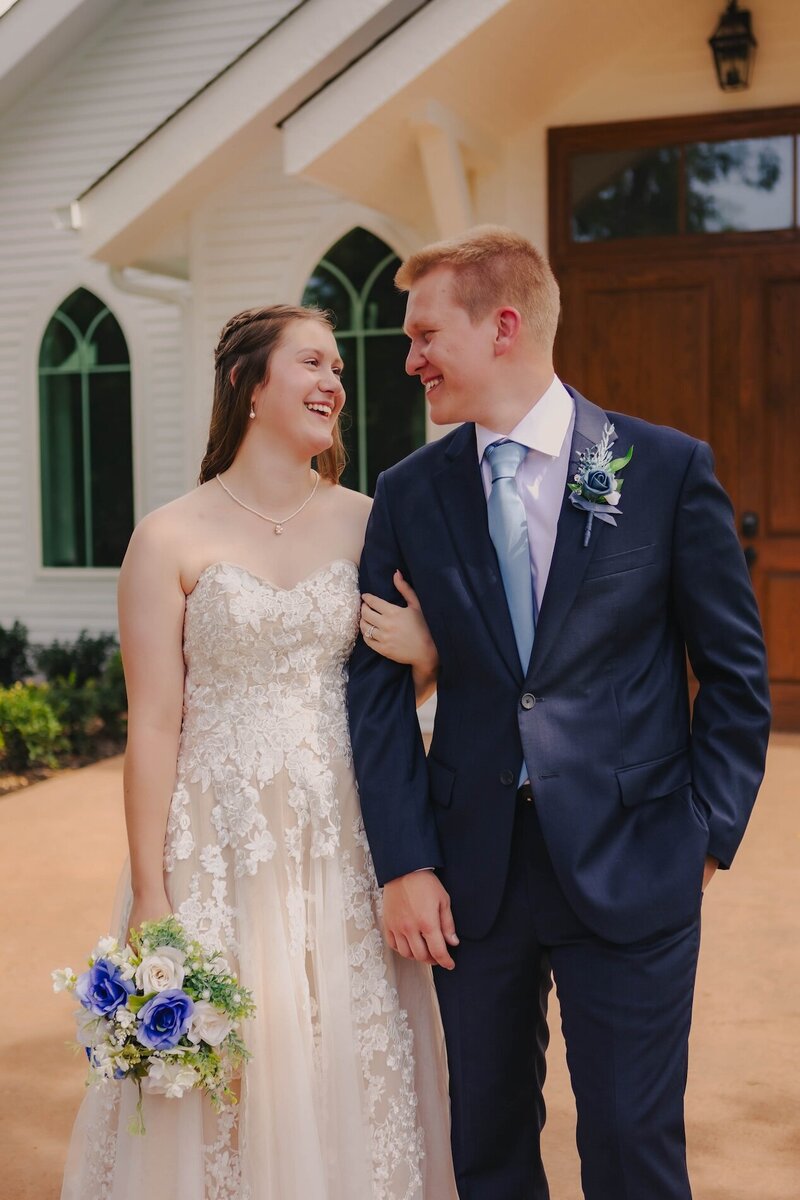 bride and groom in front of church at wedding in oklahoma