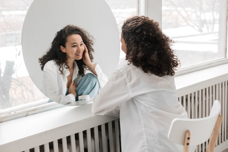 Women looking at her results in the mirror