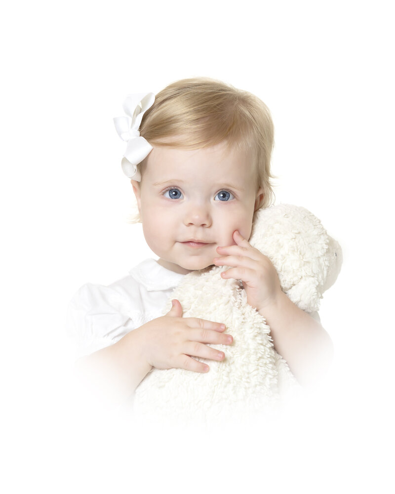 portrait of little girl holding a lovey